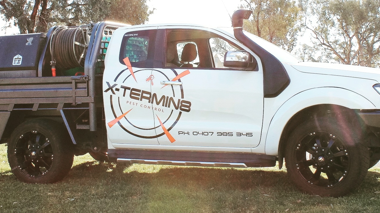 White X-TERMIN8 Pest Control ute with the logo and phone number on the door